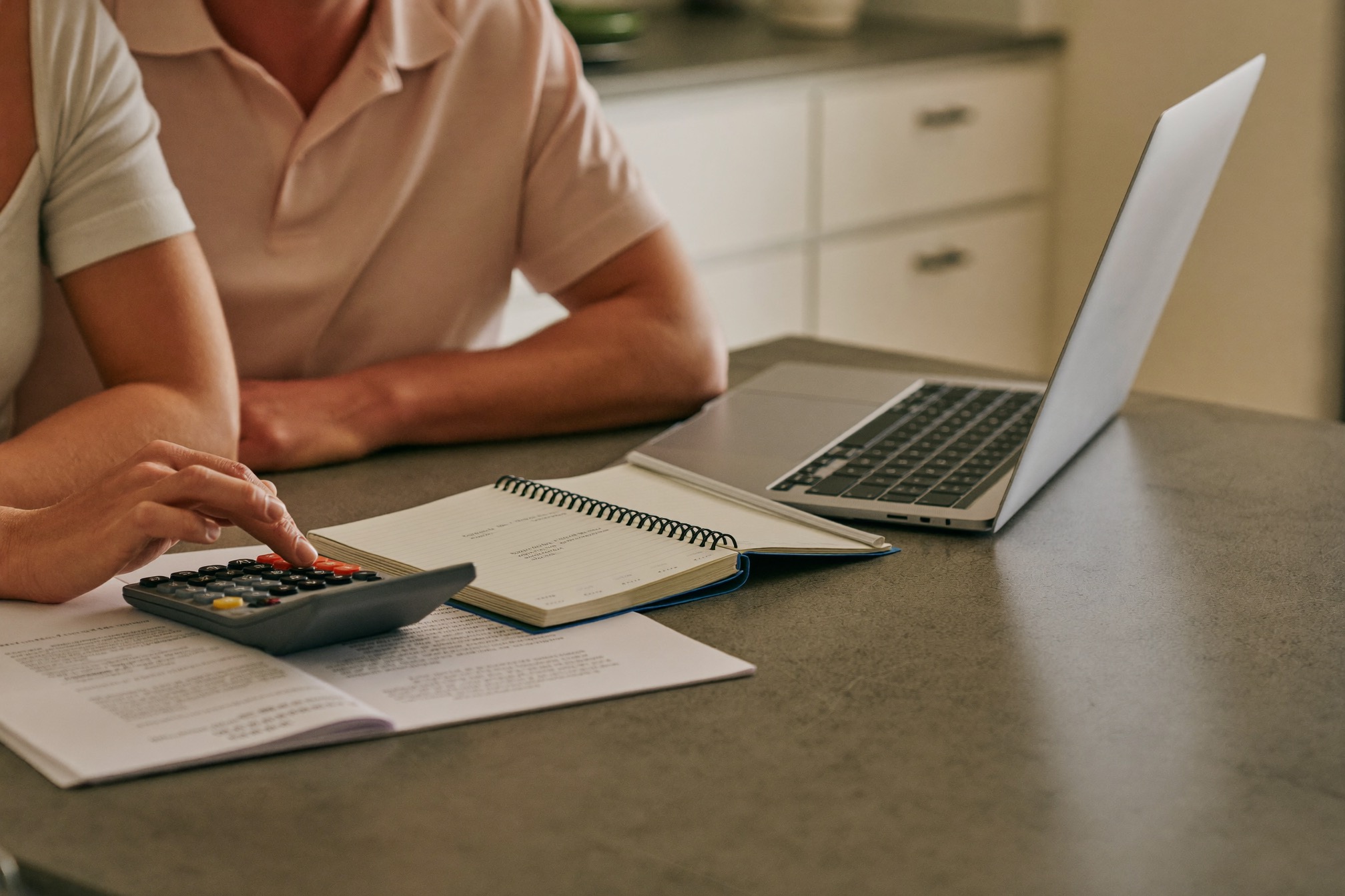 A calculator and budget paperwork on a table